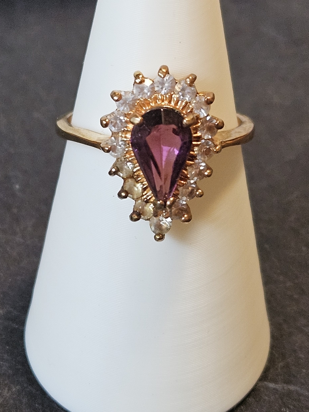 Gold-Setting Teardrop Purple Stone Surrounded By White Crystal Stones.  Size 8.5